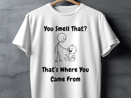White t-shirt with text "You Smell That? That's Where You Came From" and stick figures.