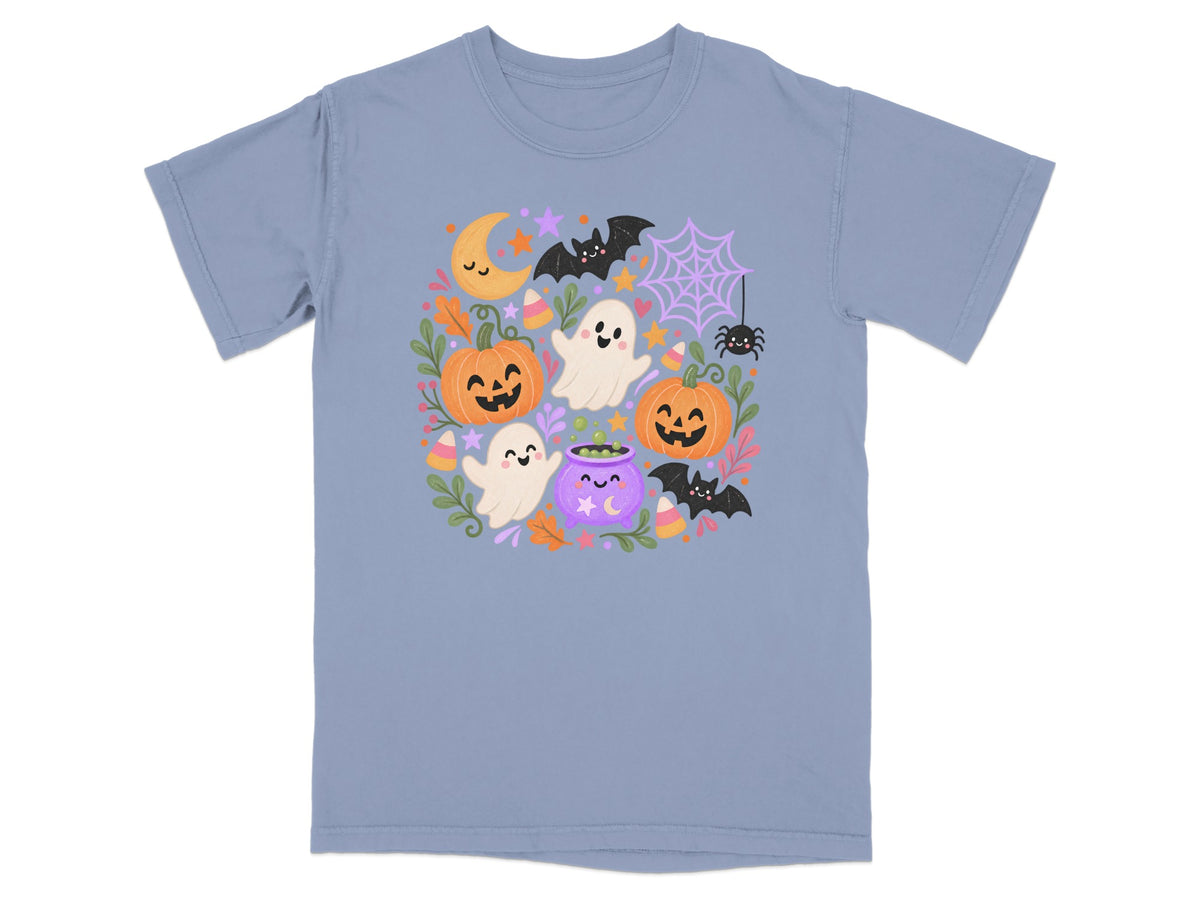 Light blue t-shirt with a whimsical Halloween pattern featuring ghosts, pumpkins, bats, and a cauldron.