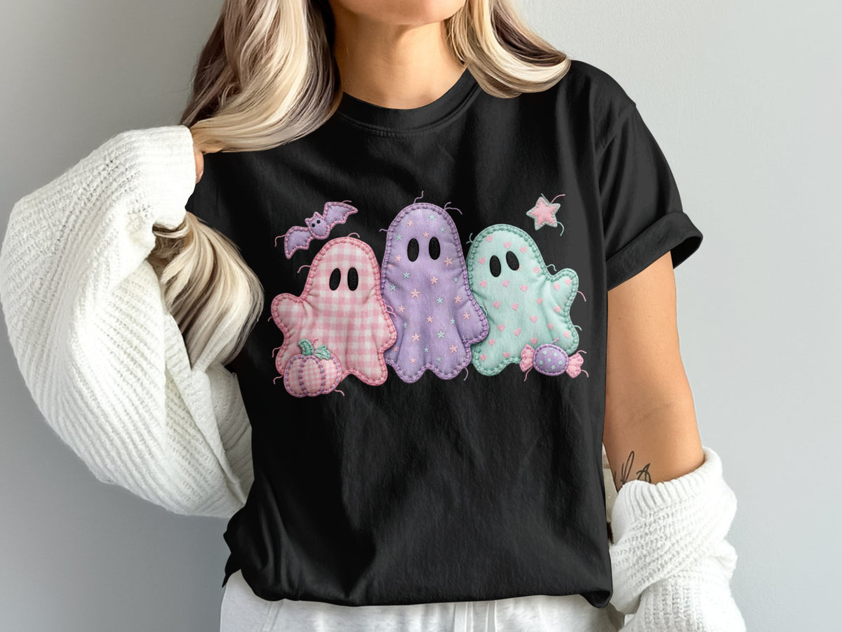 Black t-shirt with pastel ghost Halloween graphic and a white sweater.