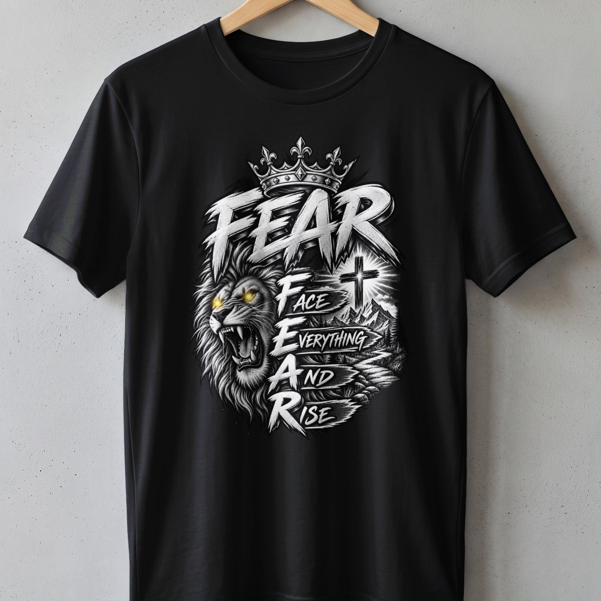 Black t-shirt with a roaring lion, crown, cross, and text "FEAR FACE EVERYTHING AND RISE".