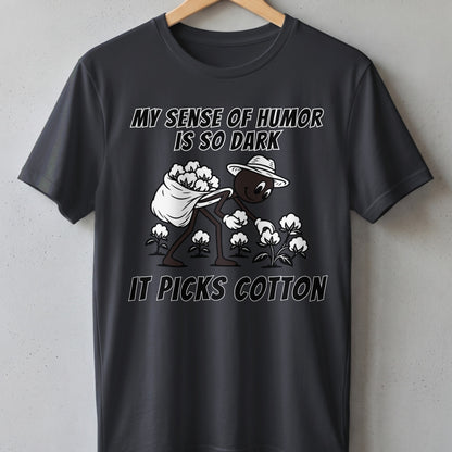 Dark gray t-shirt with text "MY SENSE OF HUMOR IS SO DARK IT PICKS COTTON."