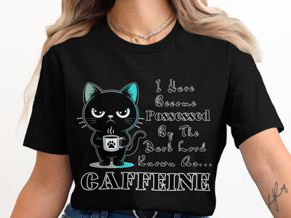 Black t-shirt with cartoon cat holding coffee cup and text "I Have Become Possessed By The Dark Lord Known As... CAFFEINE".