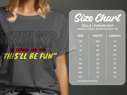 Dark gray t-shirt with text: "When God made me, he grinned and said 'This'll be fun'" and a size chart.