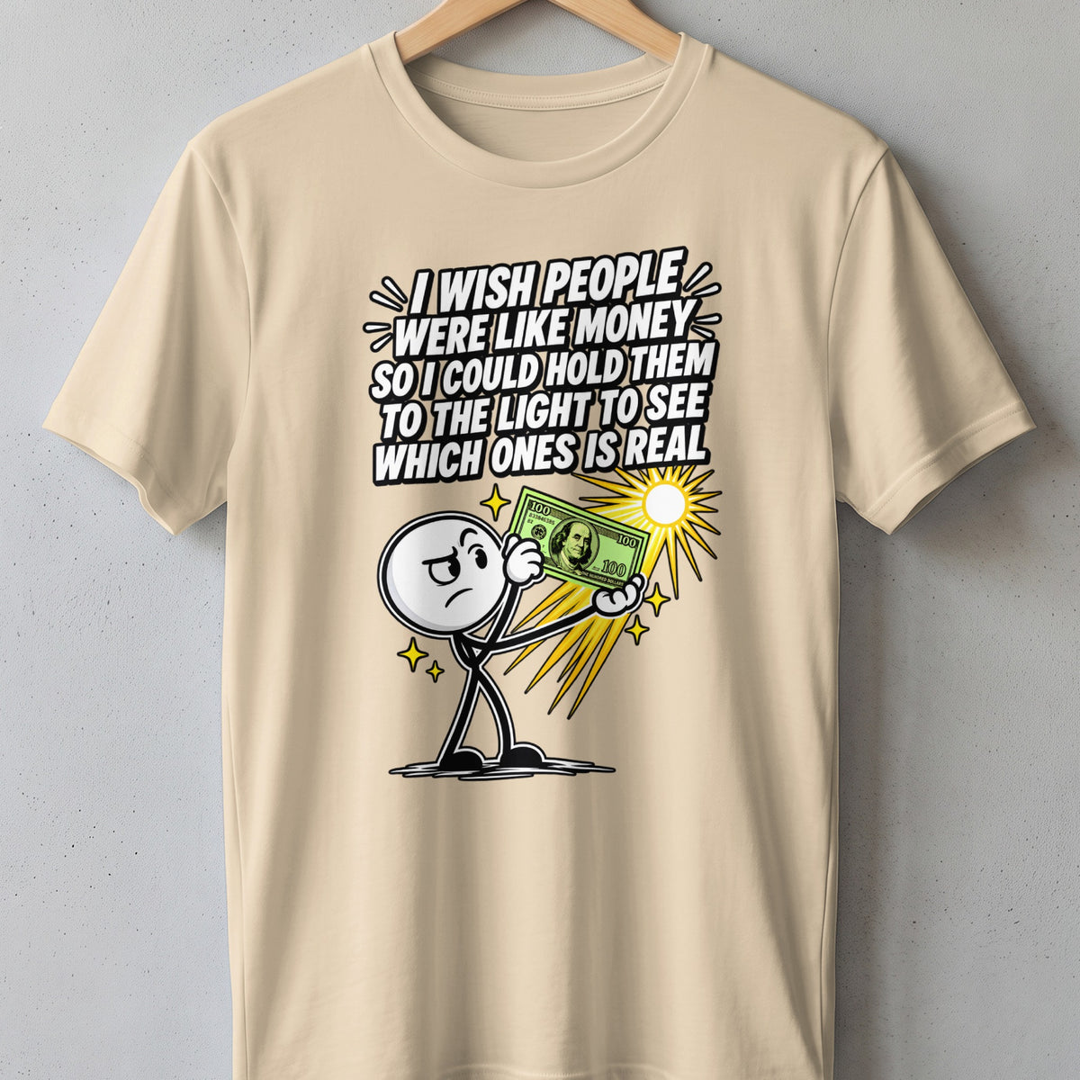 T-shirt with graphic: stick figure holds dollar bill under sun, text about money and reality.