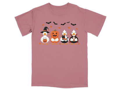 Four Halloween-themed ducks: one in a witch hat, one as a pumpkin, one with a black cat, and one as a vampire.