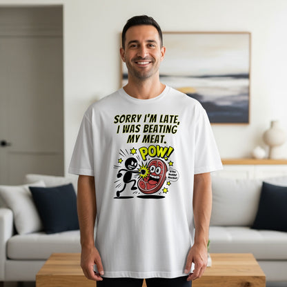 Man wearing white t-shirt with cartoon "sorry I'm late beating my meat" graphic.