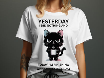 White t-shirt with black text and a cartoon black cat holding a coffee mug.