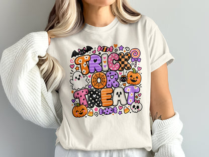 T-shirt with "Trick or Treat" in colorful Halloween-themed lettering with pumpkins and ghosts.