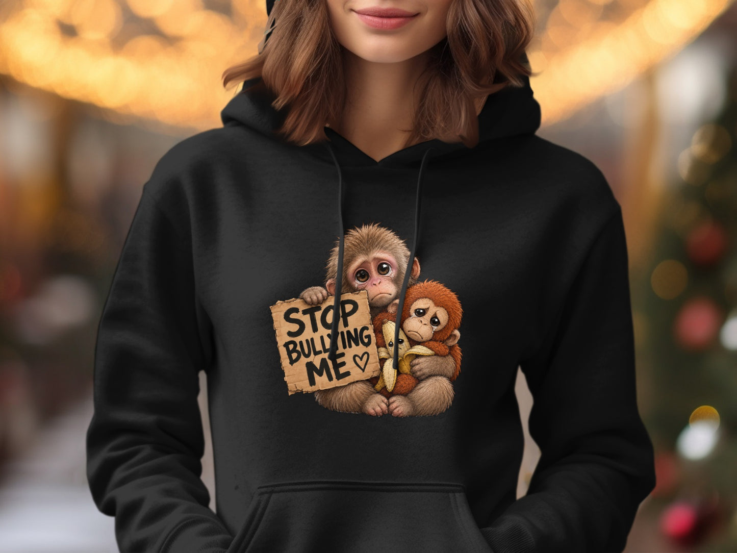 Two monkeys holding a sign that says "Stop Bullying Me" with a banana.