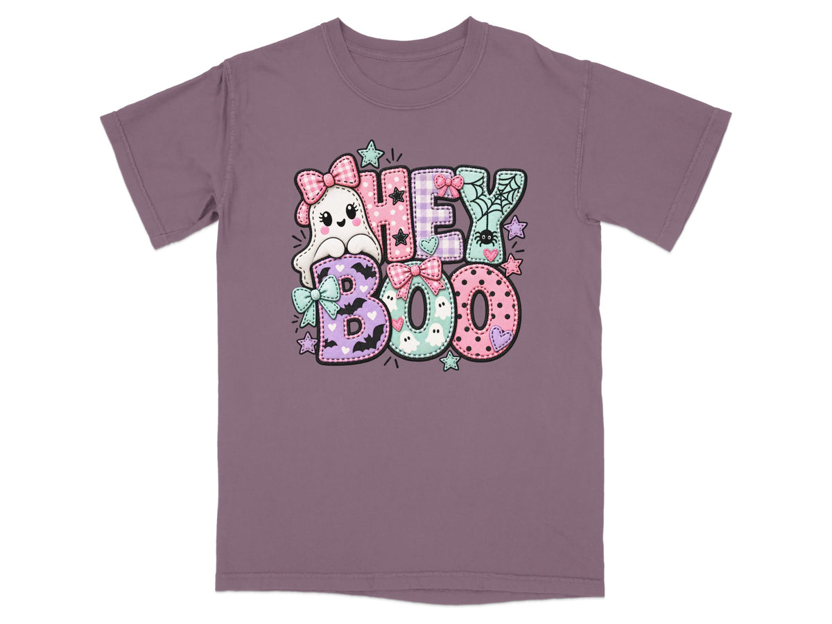 Ghost and lettering graphic reading "Hey Boo" on a purple t-shirt.