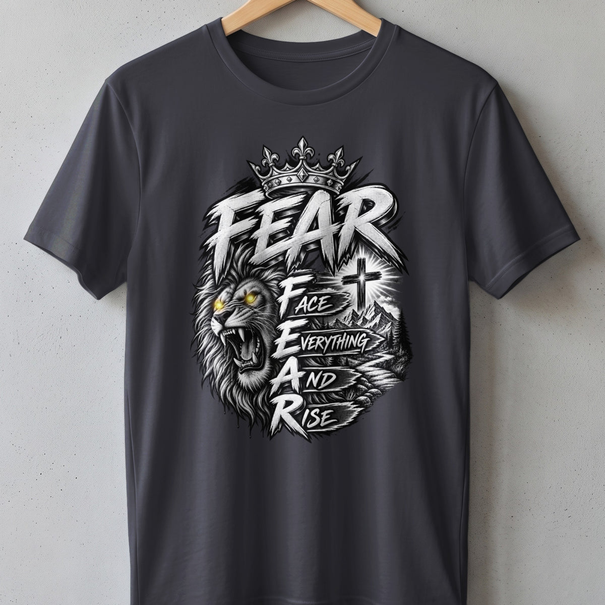 Dark grey t-shirt with a graphic of a lion, crown, cross, and mountains.