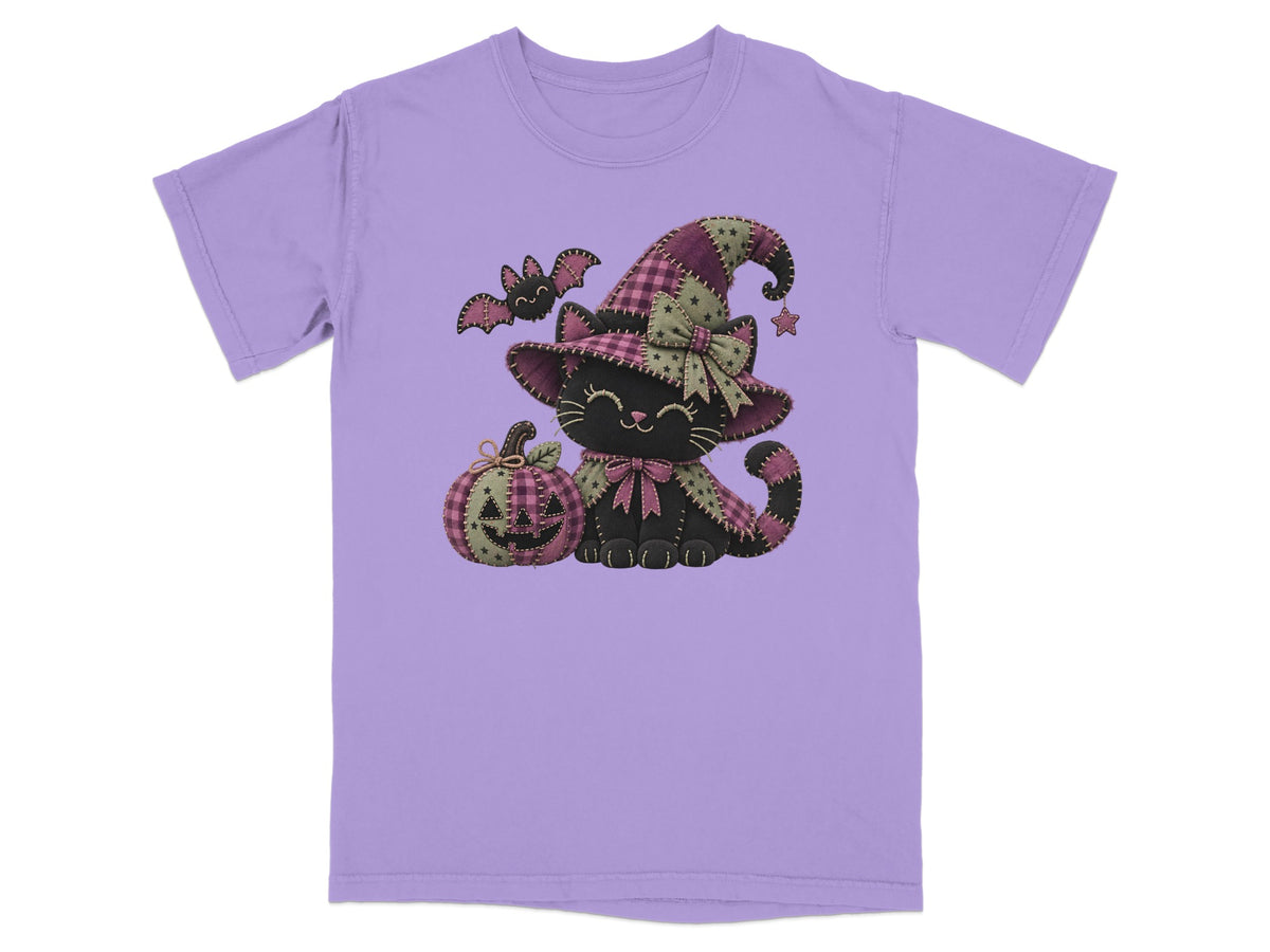 Black cat in witch hat with pumpkin and bat on purple t-shirt.