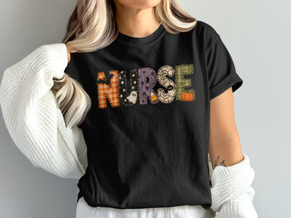 A person wears a black t-shirt printed with the word NURSE in various Halloween patterns.