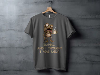 T-shirt with a cartoon zombie frog holding a coffee mug and text "Damn.... And I thought I was ugly".
