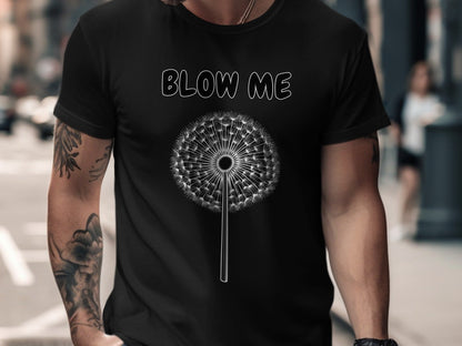 Black t-shirt with white text "BLOW ME" above a dandelion graphic.