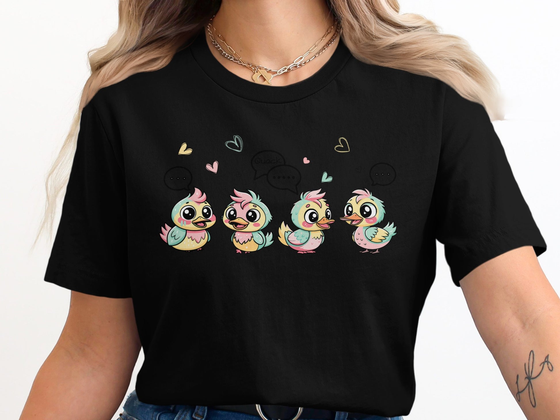Four colorful cartoon chicks with speech bubbles and hearts on a black t-shirt.
