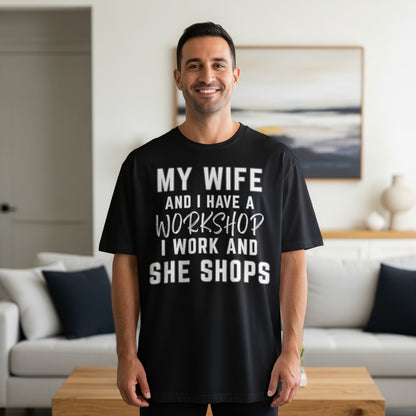 Black t-shirt with white text "My wife and I have a workshop I work and she shops."
