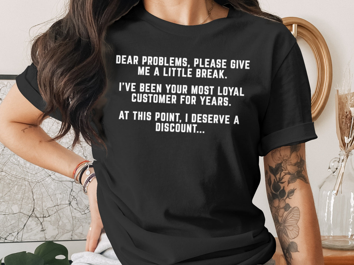 Black t-shirt with white text: "Dear problems, please give me a little break. I've been your most loyal customer for years. At this point, I deserve a discount..."