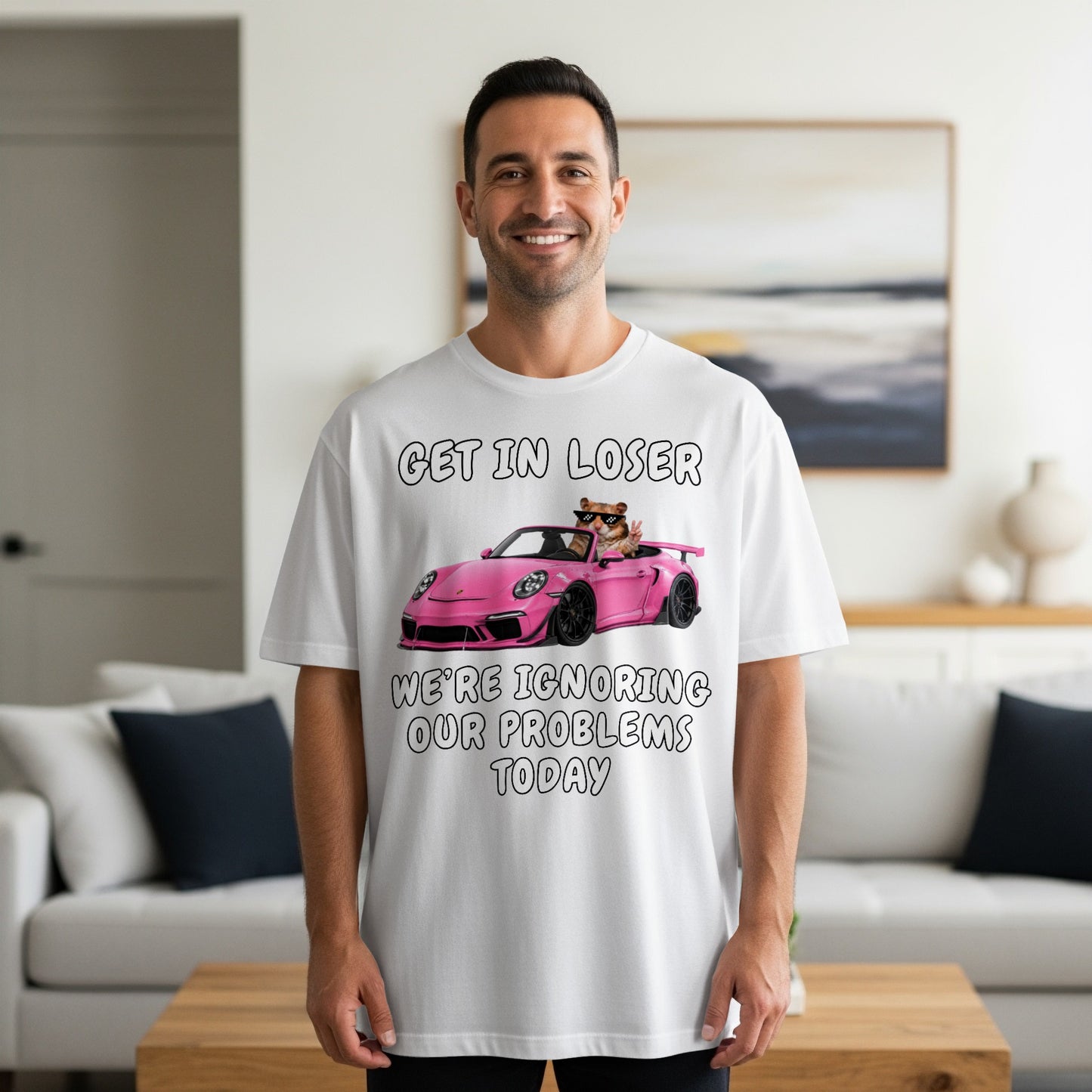 White t-shirt with "Get in loser, we're ignoring our problems today" text and cartoon.