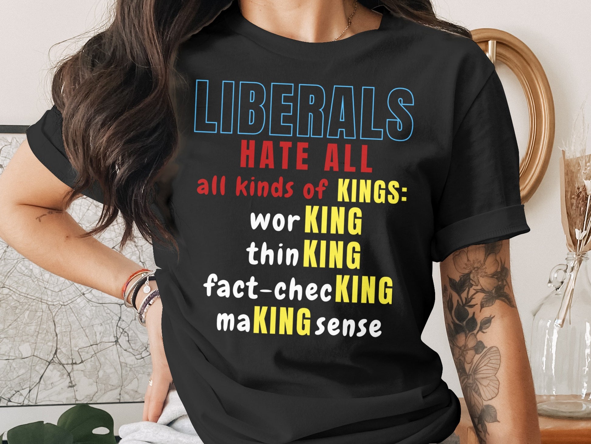 Black t-shirt with text: "LIBERALS HATE ALL all kinds of KINGS: worKING thinKING fact-checKING maKING sense"