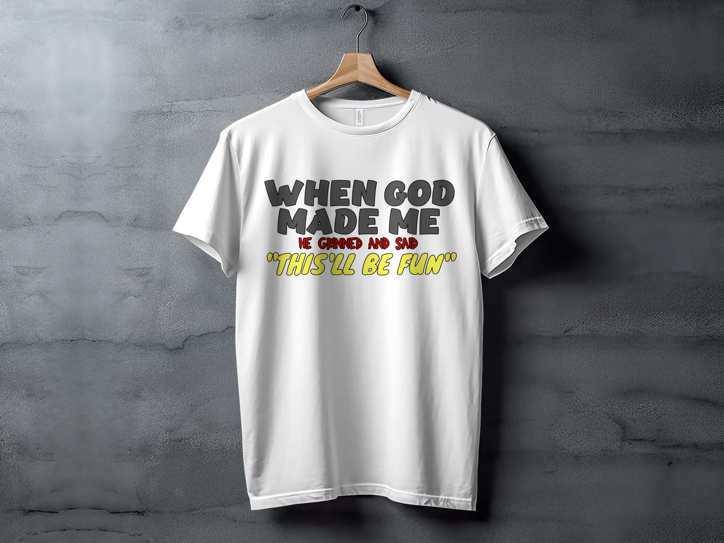 White t-shirt with text "When God Made Me He Grinned and Said 'This'll Be Fun'".
