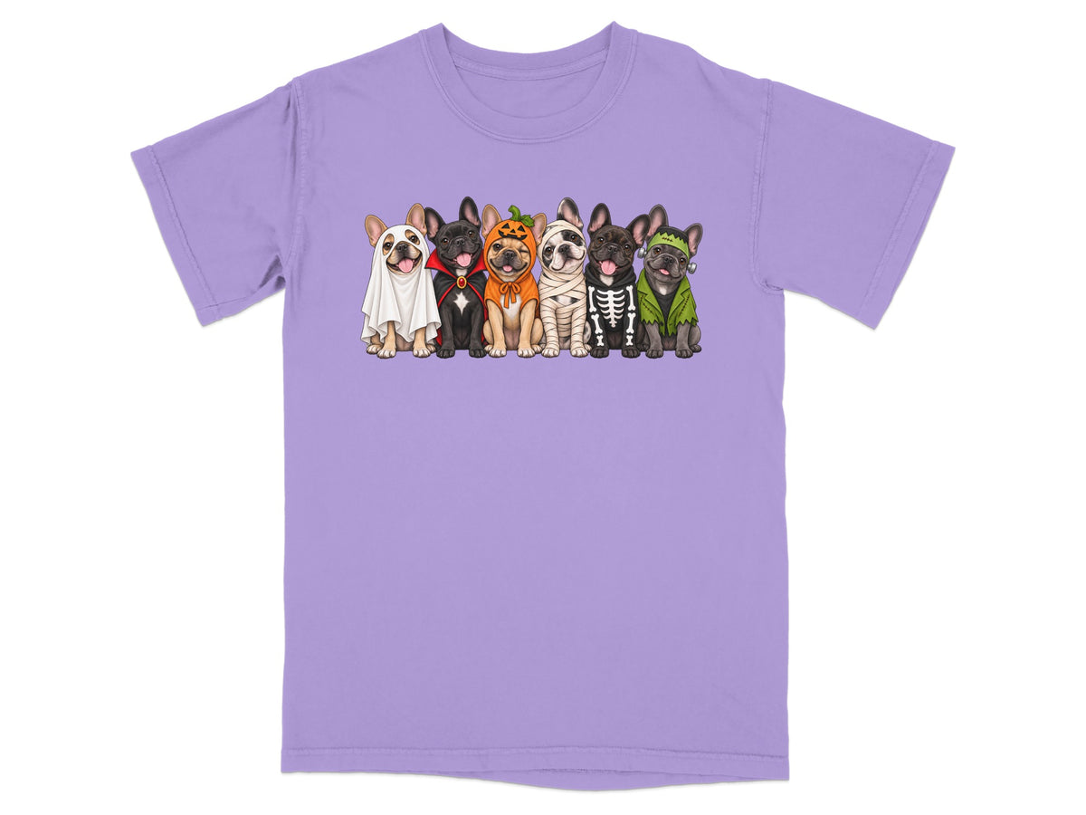 Light purple t-shirt featuring a graphic of six French bulldogs dressed in various Halloween costumes.