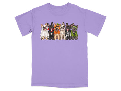 Light purple t-shirt featuring a graphic of six French bulldogs dressed in various Halloween costumes.