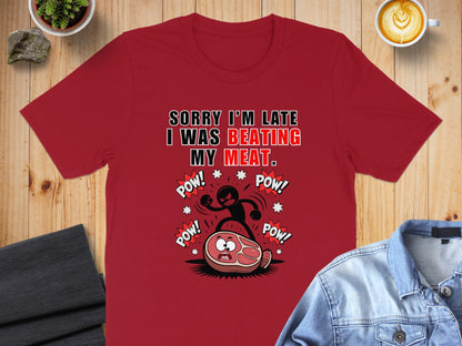 Red t-shirt with "SORRY I'M LATE I WAS BEATING MY MEAT." text and cartoon.