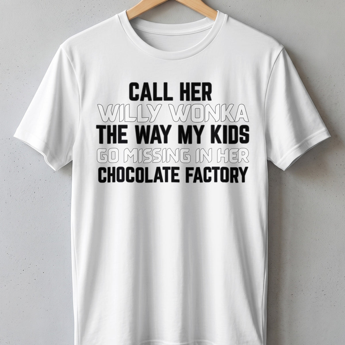 White t-shirt with black text reading "Call her Willy Wonka the way my kids go missing in her chocolate factory".