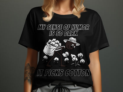 Black t-shirt with white text and a cartoon character picking cotton.