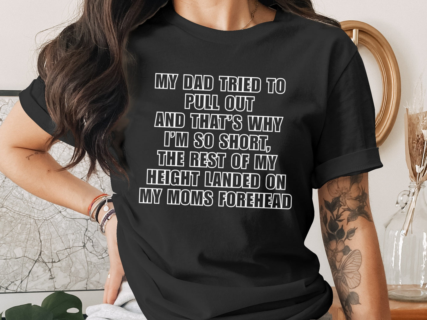 Black t-shirt with white text reading "My dad tried to pull out and that's why I'm so short, the rest of my height landed on my moms forehead."
