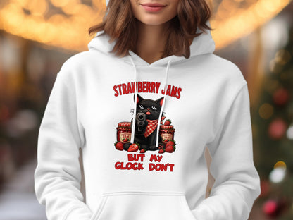 Black cat with sunglasses holding gun, surrounded by strawberry jam jars and fruit.