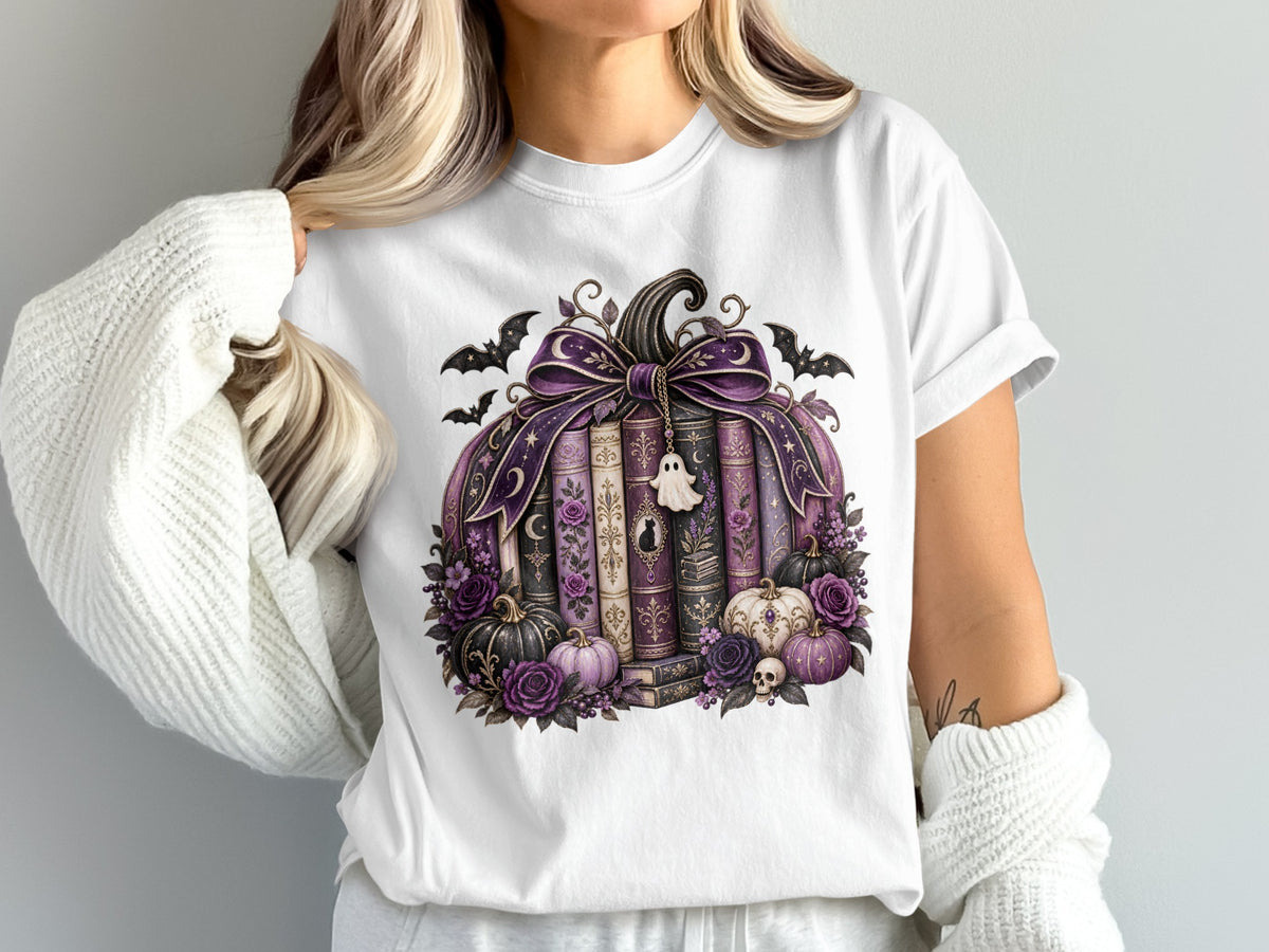White t-shirt with a pumpkin made of books, adorned with bats and purple flowers.