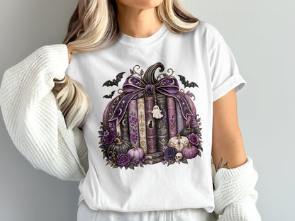 White t-shirt with a pumpkin made of books, adorned with bats and purple flowers.
