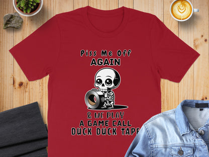 Red t-shirt with skeleton holding duct tape, text reads "Piss Me Off Again & We Play A Game Call Duck Duck Tape".