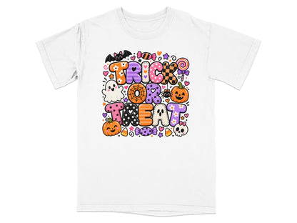 White t-shirt with "TRICK OR TREAT" text in colorful, playful Halloween graphics.