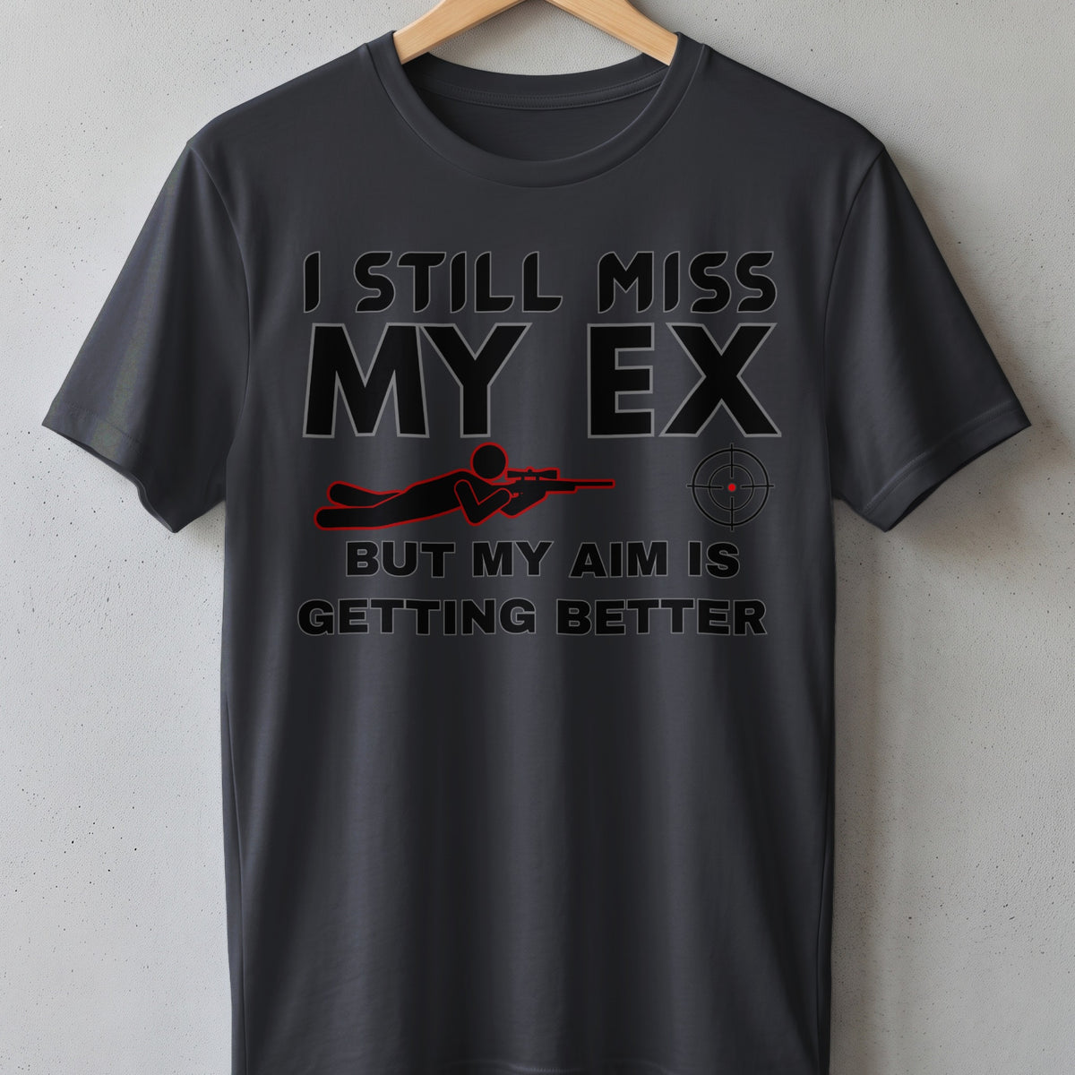 Dark grey t-shirt with "I STILL MISS MY EX BUT MY AIM IS GETTING BETTER" text.