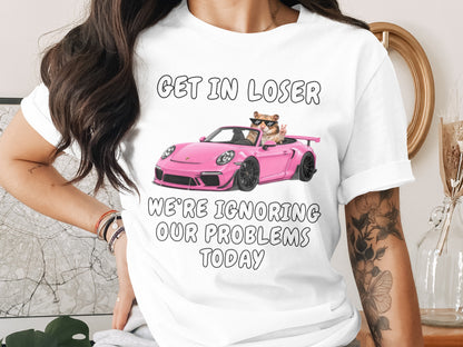 T-shirt with text "GET IN LOSER WE'RE IGNORING OUR PROBLEMS TODAY" and a hamster driving a pink car.