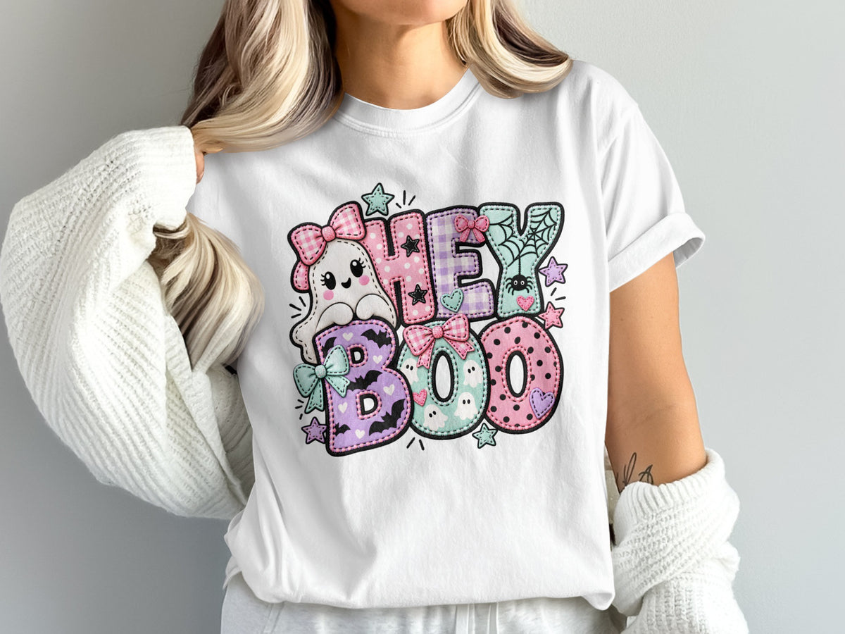 White t-shirt with pastel Halloween "Hey Boo" graphic featuring a ghost and spiders.
