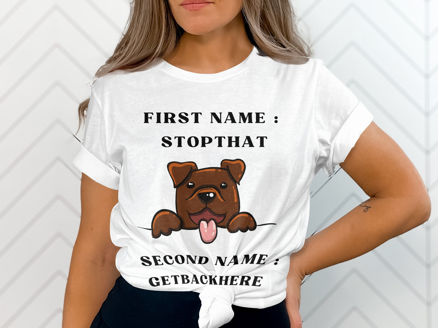 White t-shirt with cartoon dog and text "FIRST NAME: STOPTHAT SECOND NAME: GETBACKHERE".