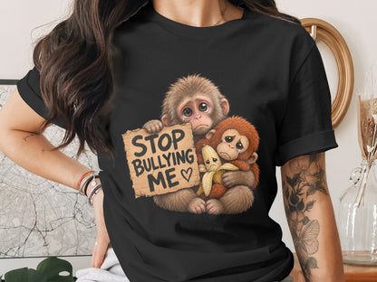Two sad monkeys holding a sign that reads "STOP BULLYING ME" and a banana.