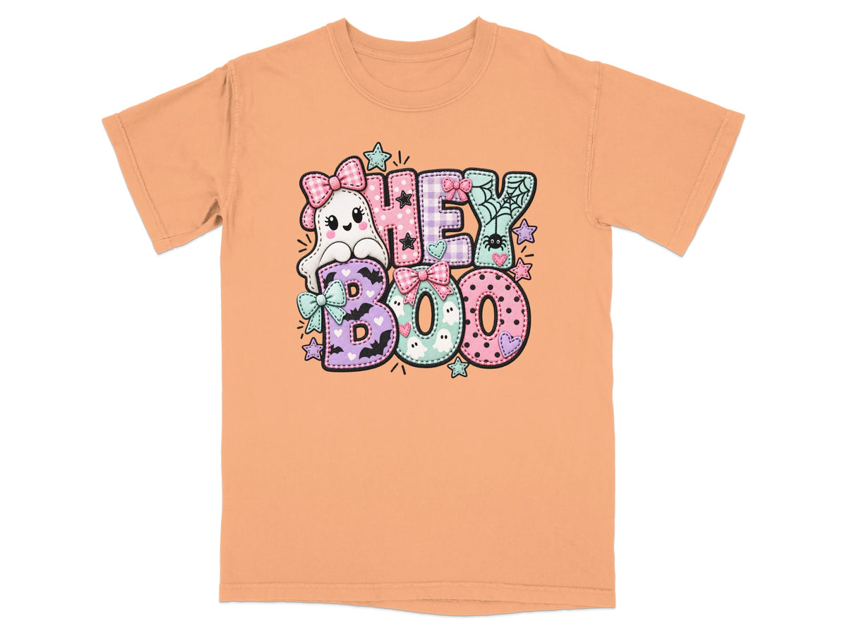 Orange t-shirt with a "Hey Boo" graphic featuring a cute ghost and colorful letters.