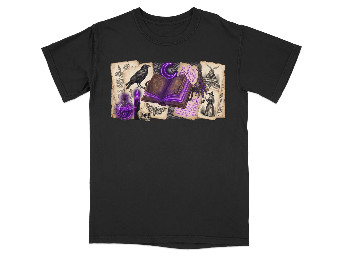 Black t-shirt with witchy illustrations of a raven, open book, skull, and potion.