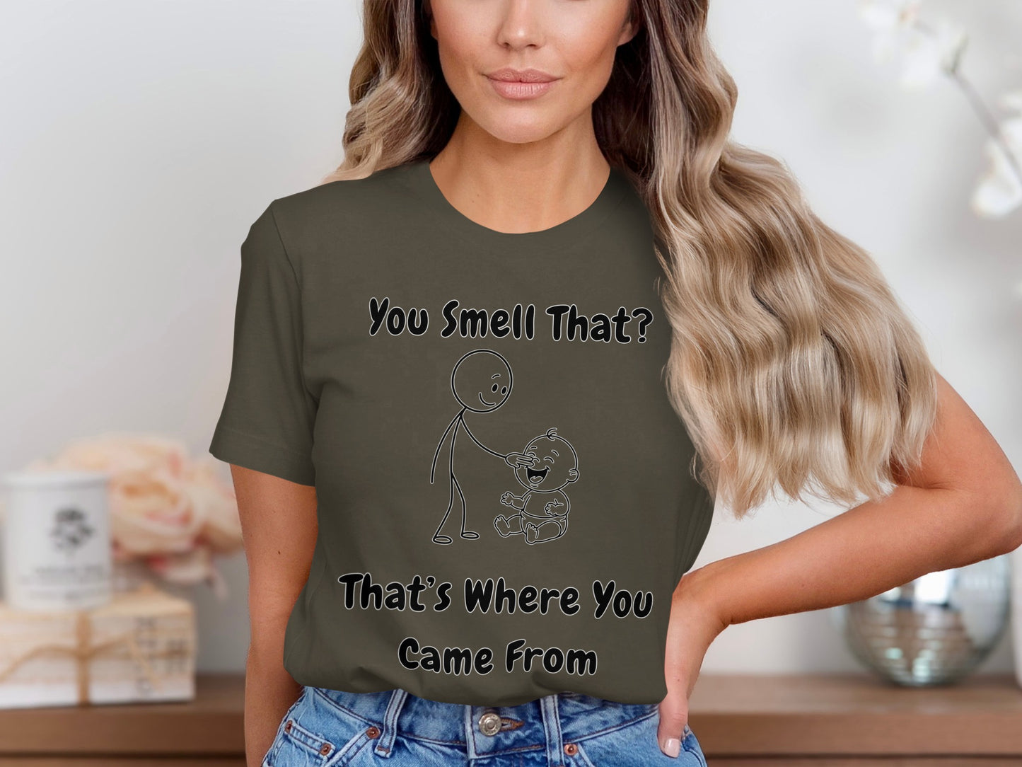 T-shirt with "You Smell That? That's Where You Came From" and stick figure drawing.