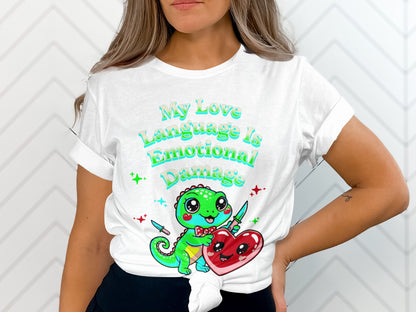 White t-shirt with text "My Love Language Is Emotional Damage" and cartoon gecko holding heart.