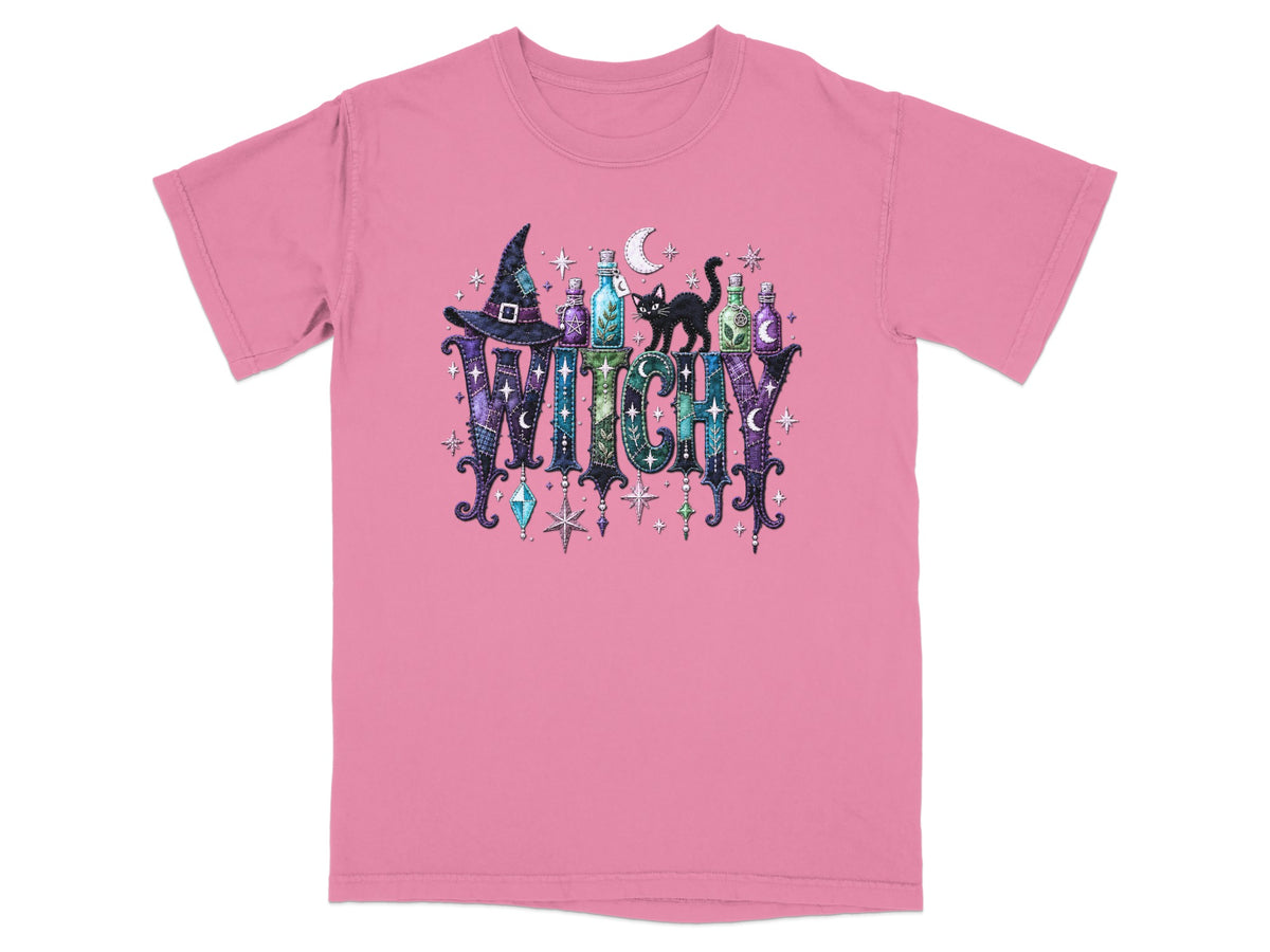 Pink t-shirt with a graphic of the word WITCHY, decorated with potion bottles, a black cat, and stars.