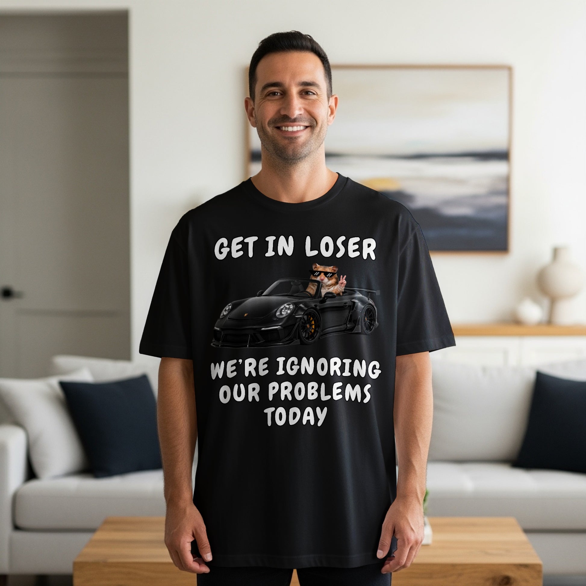 Black t-shirt with text and image of a cat driving a car.