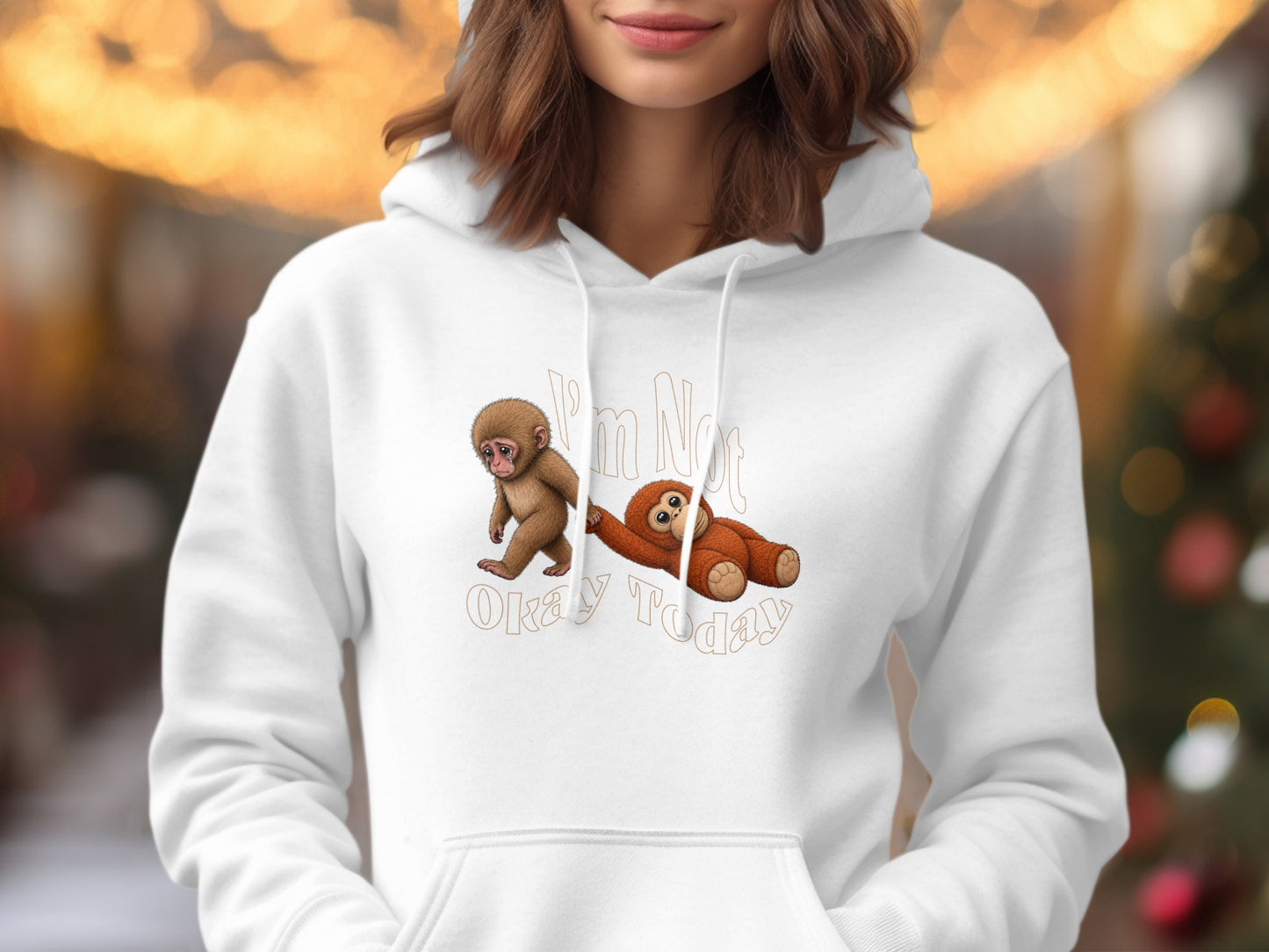White hoodie with "I'm Not Okay Today" text and cartoon monkey and sloth graphics.