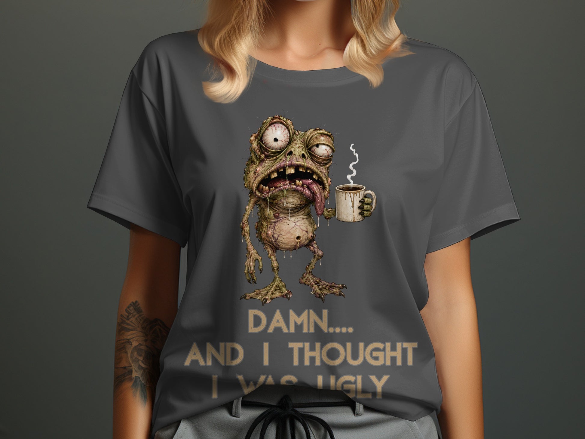 Graphic t-shirt with a slimy creature holding a coffee mug and text.