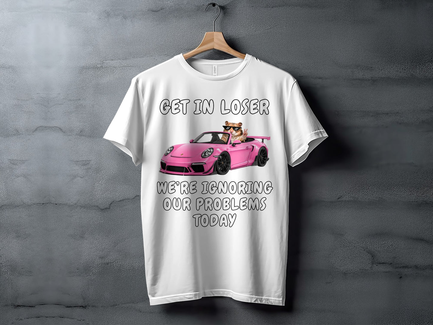 White t-shirt with graphic of cat in sunglasses driving pink sports car and text.